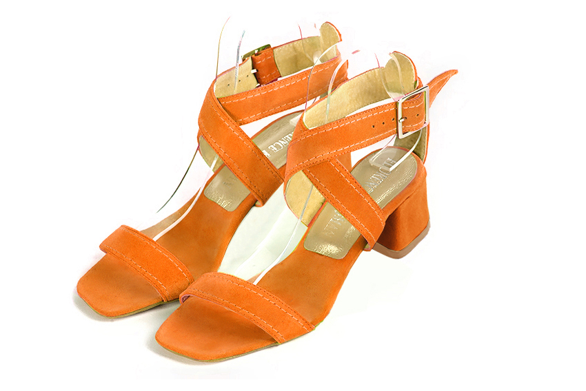 Apricot orange elegant sandals with cross straps across the instep, fully open. Square toe. Low flare heels.